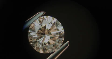 Diamond under microscope held by tweezers. Engagement concept Stock Footage 247374708