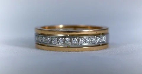 Diamond wedding golden ring macro shot. Transfusion of light on rings. Video stock 77078536