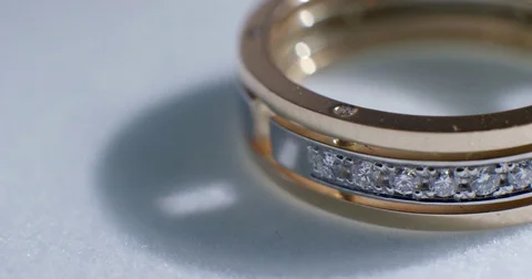 Diamond wedding golden ring macro shot. Transfusion of light on rings. Stock Footage 77078808
