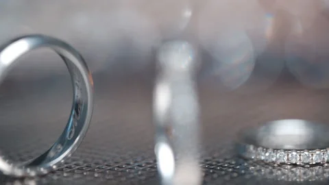 Diamond Wedding Rings Lying On Silver Surface. Ring Engraved With Date.  Macro. Stock Footage 198347093