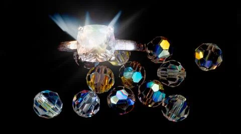 Diamonds and ring on black background Stock Photos