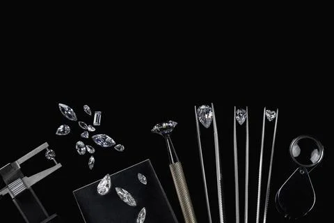 Diamonds of different sizes at the workplace of diamond dealer evaluating Stock Photos