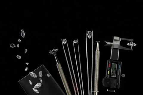 Diamonds of different sizes at the workplace of diamond dealer evaluating Stock Photos