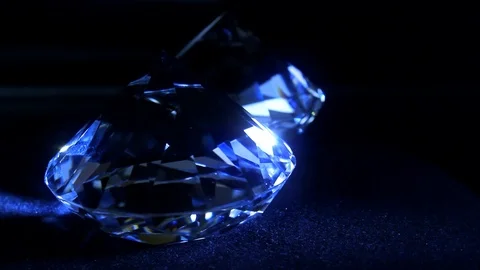 Diamonds shining and rolling on a black cloth showcase background. Stock Footage 89558351