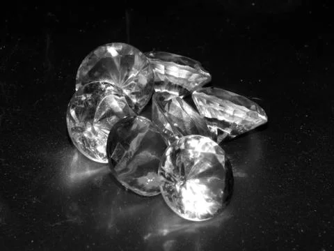 Diamonds on a silver background close-up Stock Photos