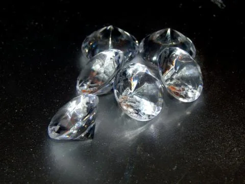 Diamonds on a silver background close-up Stock Photos