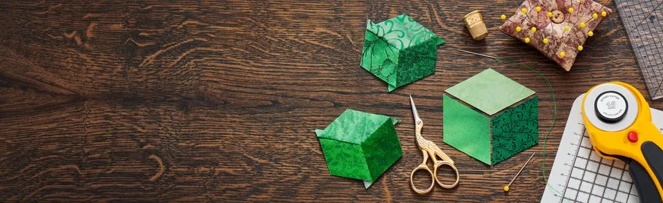 Diamonds stitched in the form of a cube. The process of sewing a quilt. Stock Photos