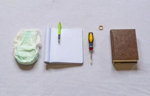 Diaper notebook with handle screwdriver ring and book on white background Stock Photos