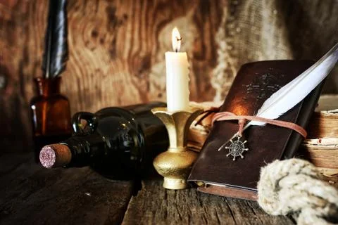 Diary and feather with a bottle of rum Foto stock