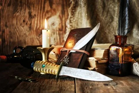 Diary and feather with a bottle of rum Foto stock