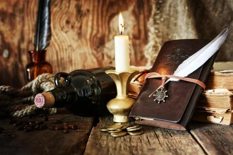Diary and feather with a bottle of rum Foto stock