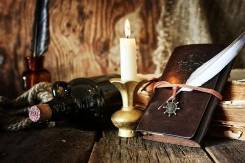 Diary and feather with a bottle of rum Foto stock