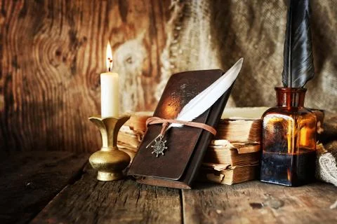 Diary and feather with a bottle of rum Foto stock