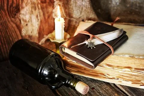 Diary and feather with a bottle of rum Stock Photos