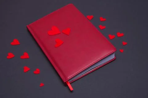 Diary with hearts on a dark background Stock Photos