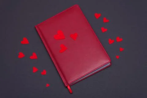 Diary with hearts on a dark background Stock Photos