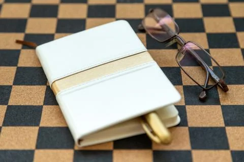 Diary, journal and reading glasses. Old-fashioned way to keep organized. Stock Photos