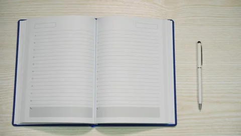 A diary with a money bookmark opens to a blank page and closes and walks away Video stock 301438088