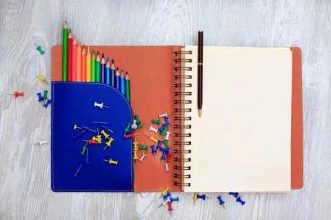 Diary notebook and colored pens on wooden background. Stock Photos