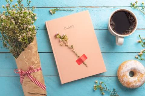 Diary notebook and delicious breakfast on a wooden table. Stock Photos
