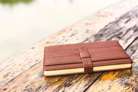 A diary on old wood table. Stock Photos