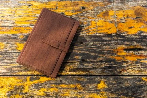 A diary on old wood table. Stock Photos