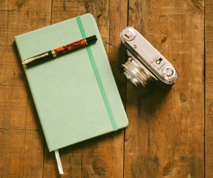 Diary with pen and old camera Stock Photos