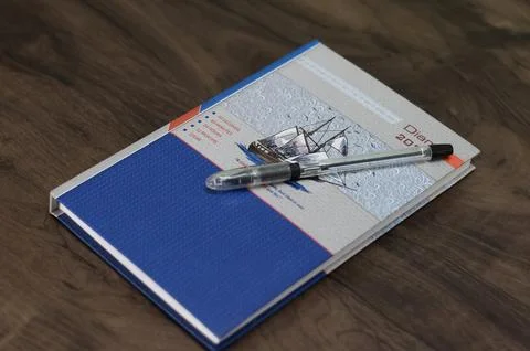 Diary with the pen on the office table Foto stock