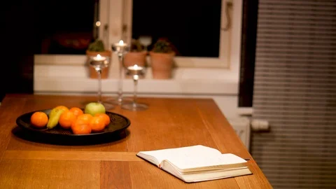 Diary on Table with Fruit and Candles by Window Stock Footage 85667521