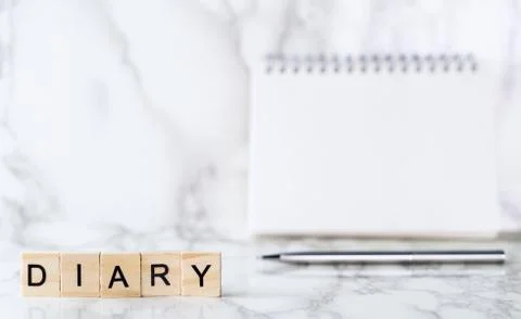 Diary text with blank notebook in background 库存照片