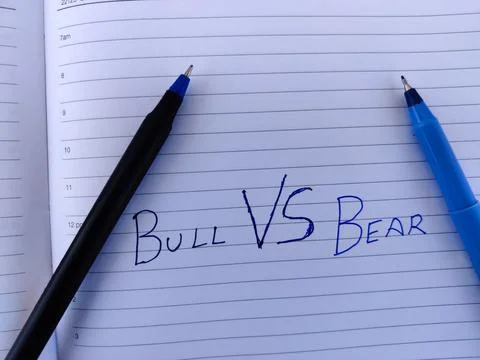 A diary with text BULL VS BEAR and two pens. Stock market concept Stock Photos