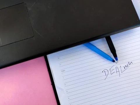 A diary with text Dealing and two pens Stock Photos