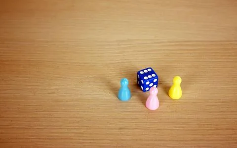 Dice and multi-colored chips lie on the table. Place for text Stock Photos