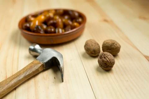 Dice and nuts on a background of pine wood. Stock Photos