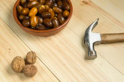 Dice and nuts on a background of pine wood. Stock Photos