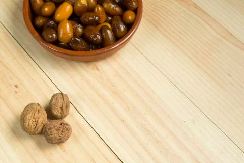 Dice and nuts on a background of pine wood. Stock Photos