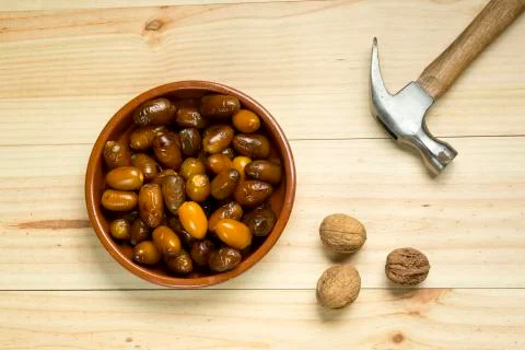 Dice and nuts on a background of pine wood. Stock Photos