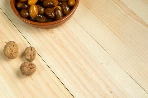 Dice and nuts on a background of pine wood. Stock Photos