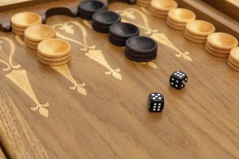 Dice on a backgammon board close-up Stock Photos
