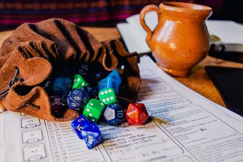 Dice bag filled with multicolor dice Stock Photos