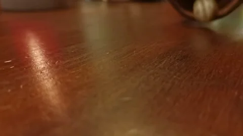 Dice being rolled out of a cup onto a wooden interior table. Static close Stock Footage 174787329