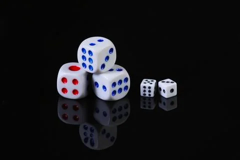 Dice on a black background with reflection. Fortune, gaming addiction 写真素材