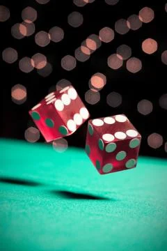Dice bouncing on a green table Stock Photos