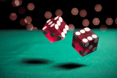 Dice bouncing on a green table Stock Photos