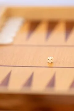 Dice cube on traditional backgammon board Stock Photos