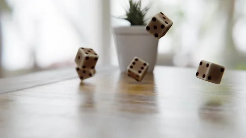 Dice cubes falling on a wooden table Stock Footage 253561848