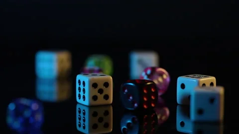 Dice of different colors scattered on a black background close-up 動画素材 214361266