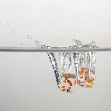 Dice drop in water Stock Photos