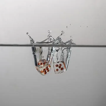 Dice drop in water Stock Photos