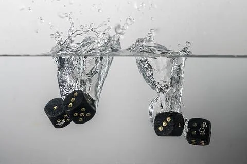 Dice drop in water Stock Photos